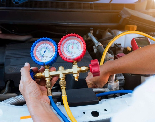 Auto Super Shoppes mechanic servicing a European car air conditioning system
