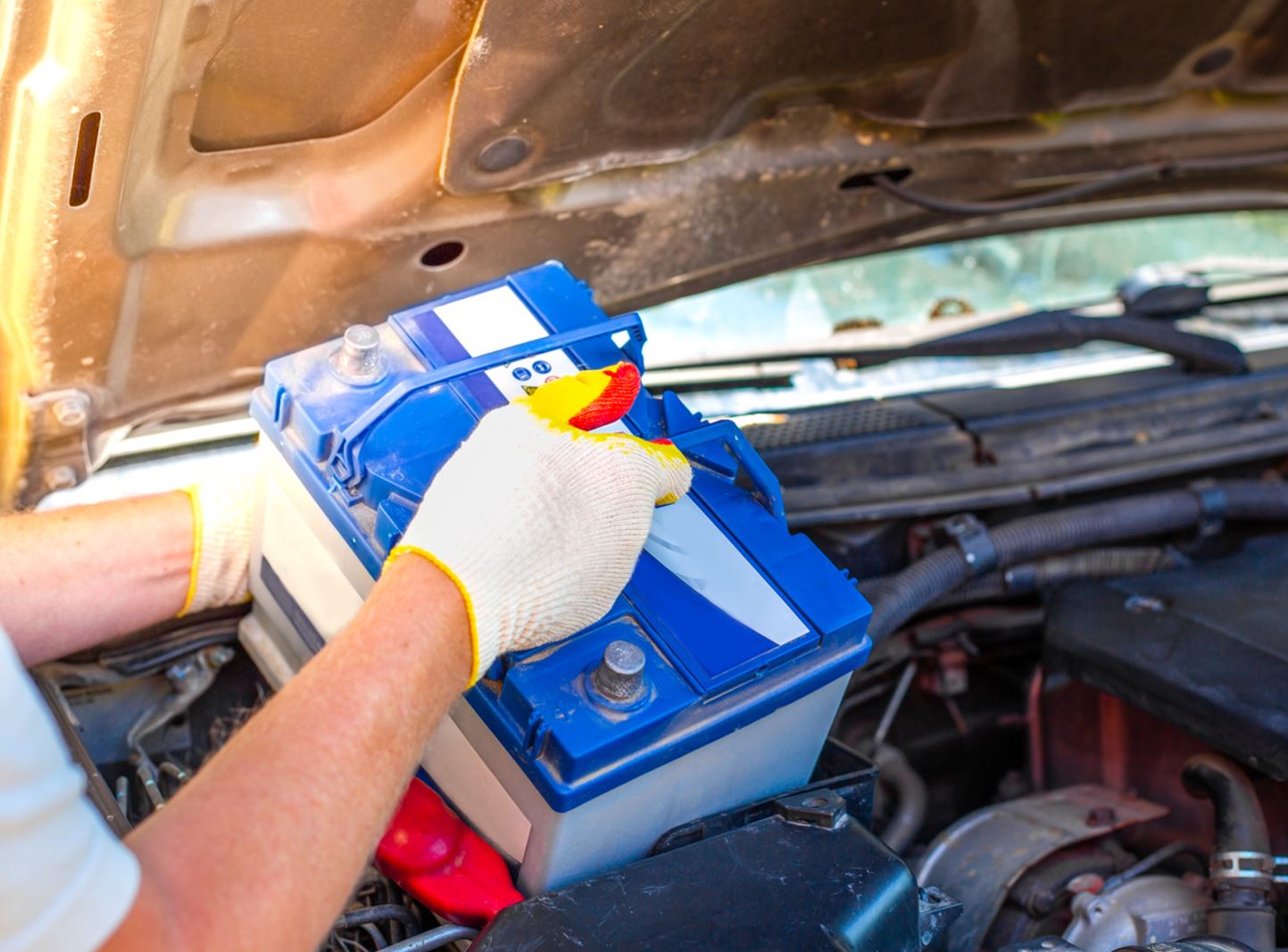 Auto Super Shoppes mechanic replacing a car battery